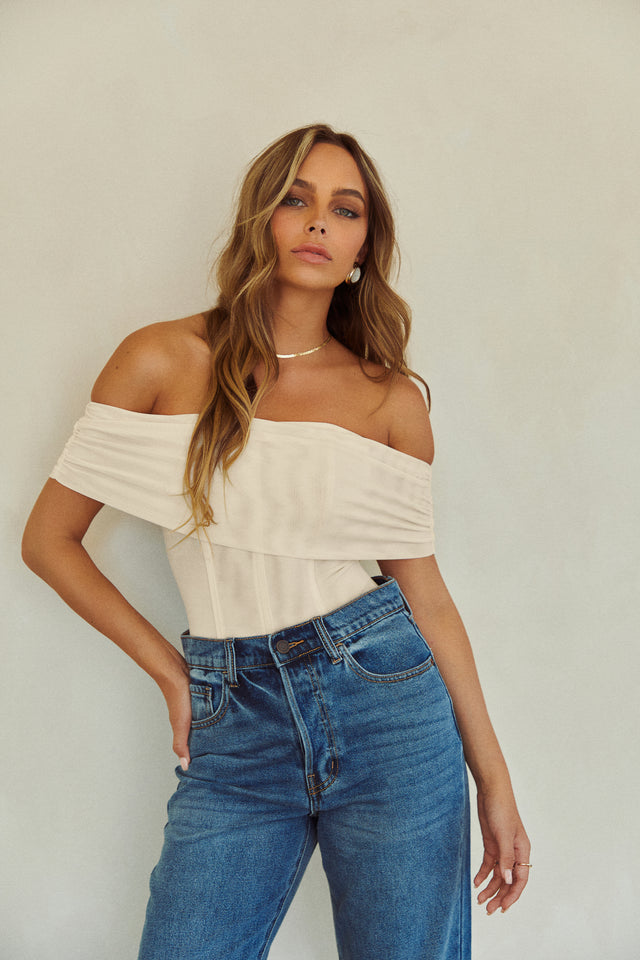 Load image into Gallery viewer, Off The Shoulder Cream Corset Top Styled with High Waist Jeans
