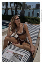 Load image into Gallery viewer, Girl Sitting Poolside Wearing Brown Bikini with White Contrast
