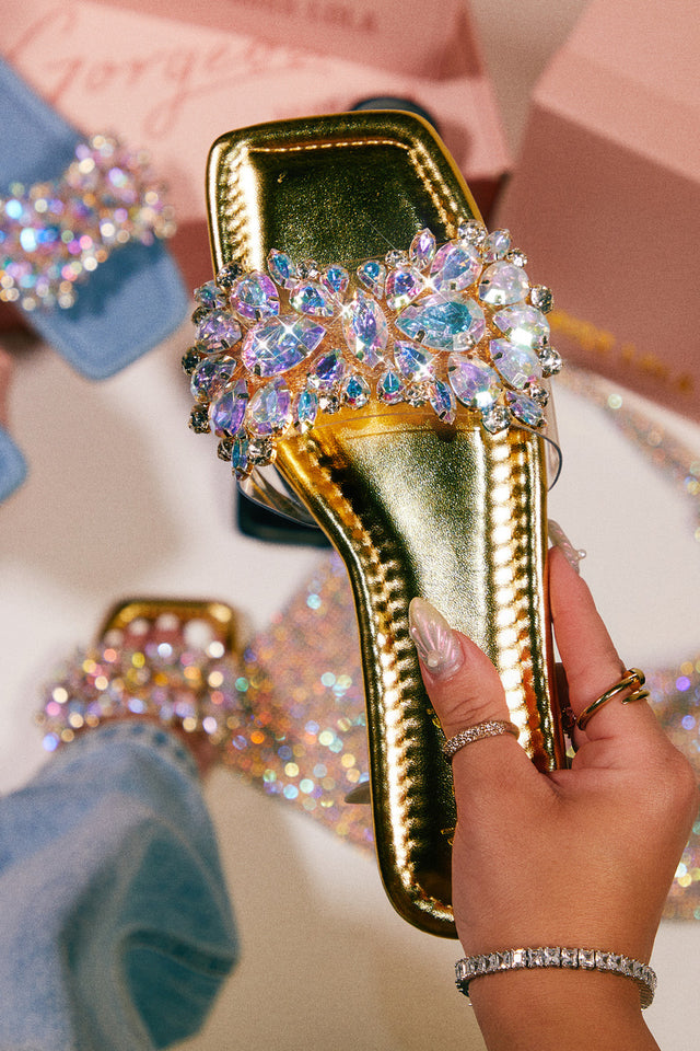 Load image into Gallery viewer, Women Holding Gold Sandals
