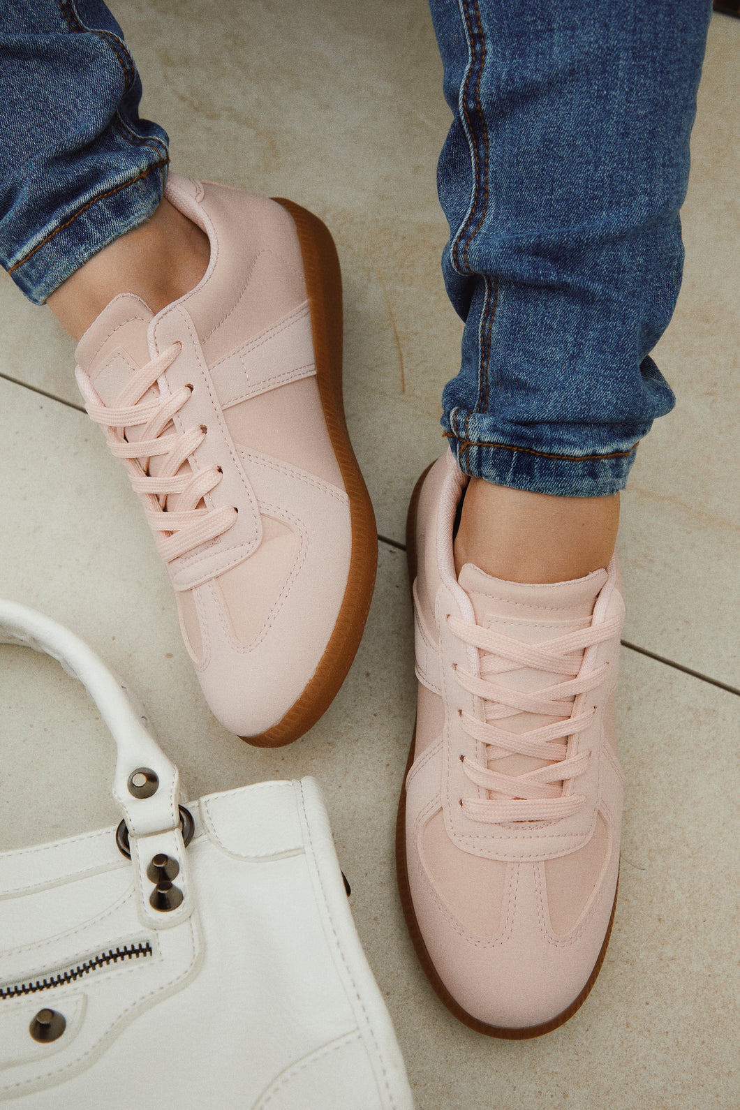 Women Wearing Pink Lace Up Sneakers