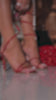 Red embellished coil heels on model