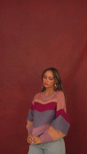 Video of model wearing multi color knit sweater