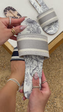 Load and play video in Gallery viewer, video of grey slip on sandals
