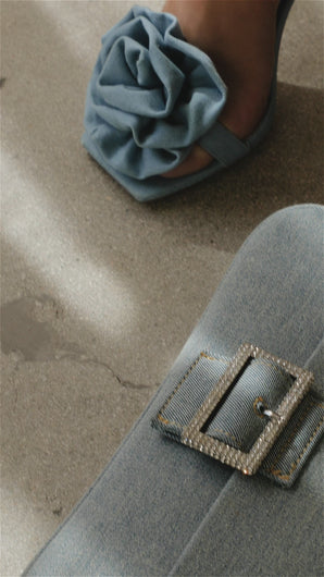 Model wearing denim rosette detailed heels