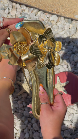  Video of Women Holding Gold-Tone Slip On Sandals with Flower Strap