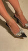 Model wearing black single sole pumps
