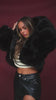 Video of model wearing black faux fur jacket