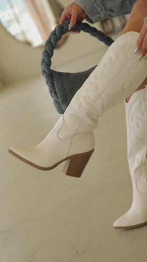 Video of white cowgirl boots on model