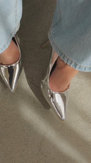 Model wearing silver pumps video