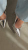 Model wearing silver pumps video