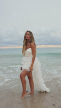 Load and play video in Gallery viewer, Model wearing ivory ruffle dress on shore video
