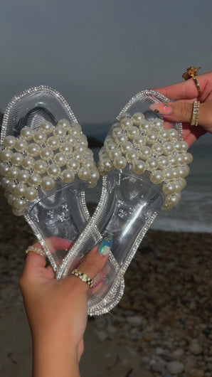 Video of clear jelly pearl embellished slip on sandals