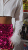 Video of model wearing white button up with feathery cuffs