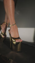 Load and play video in Gallery viewer, Model strutting in gold tone platform heels
