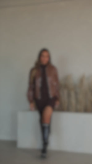 Model wearing brown faux leather jacket