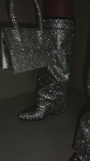 Video of black rhinestone embellished boots on model 