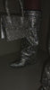 Video of black rhinestone embellished boots on model 
