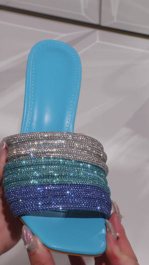 Model wearing blue embellished high heel mules video