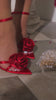 Video of red embellished rose heels