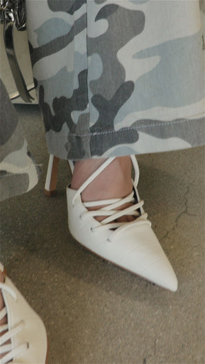 Model wearing white lace up heels video