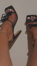 Load and play video in Gallery viewer, black heels with embellished bow straps on model
