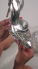 Video of silver high heel pump on model