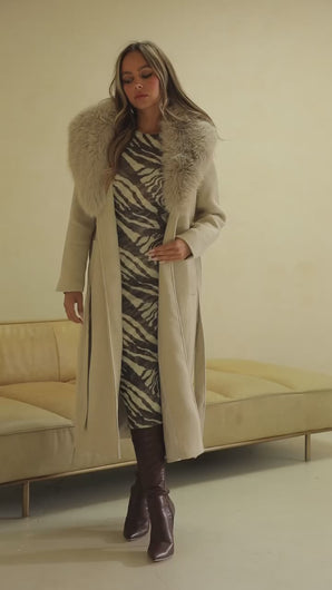 Video of cream trench coat on model