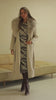 Video of cream trench coat on model