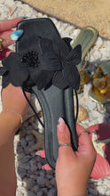 Load and play video in Gallery viewer, Video of Black Slip On Sandals with Flower Strap
