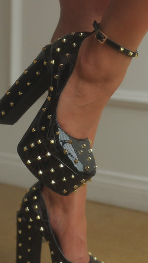 Video of model wearing black studded high heel platforms