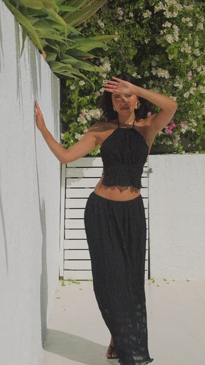 Video of model wearing black skirt set