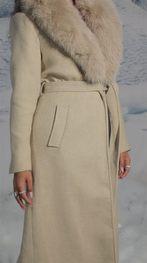 Video of cream trench coat on model