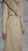 Video of cream trench coat on model