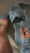 Load and play video in Gallery viewer, Woman holding denim rose detailed sandal
