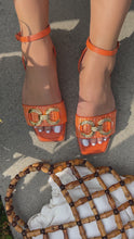 Load and play video in Gallery viewer, orange sandals with gold tone hardware embellishment
