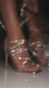 Model lacing up silver embellished heels video