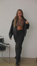 Load and play video in Gallery viewer, Video of model wearing black denim maxi skirt styled
