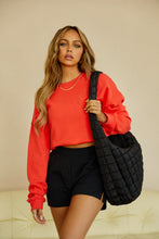 Load image into Gallery viewer, Model Wearing Red Sweater Styled with Shorts, and Oversized Bag
