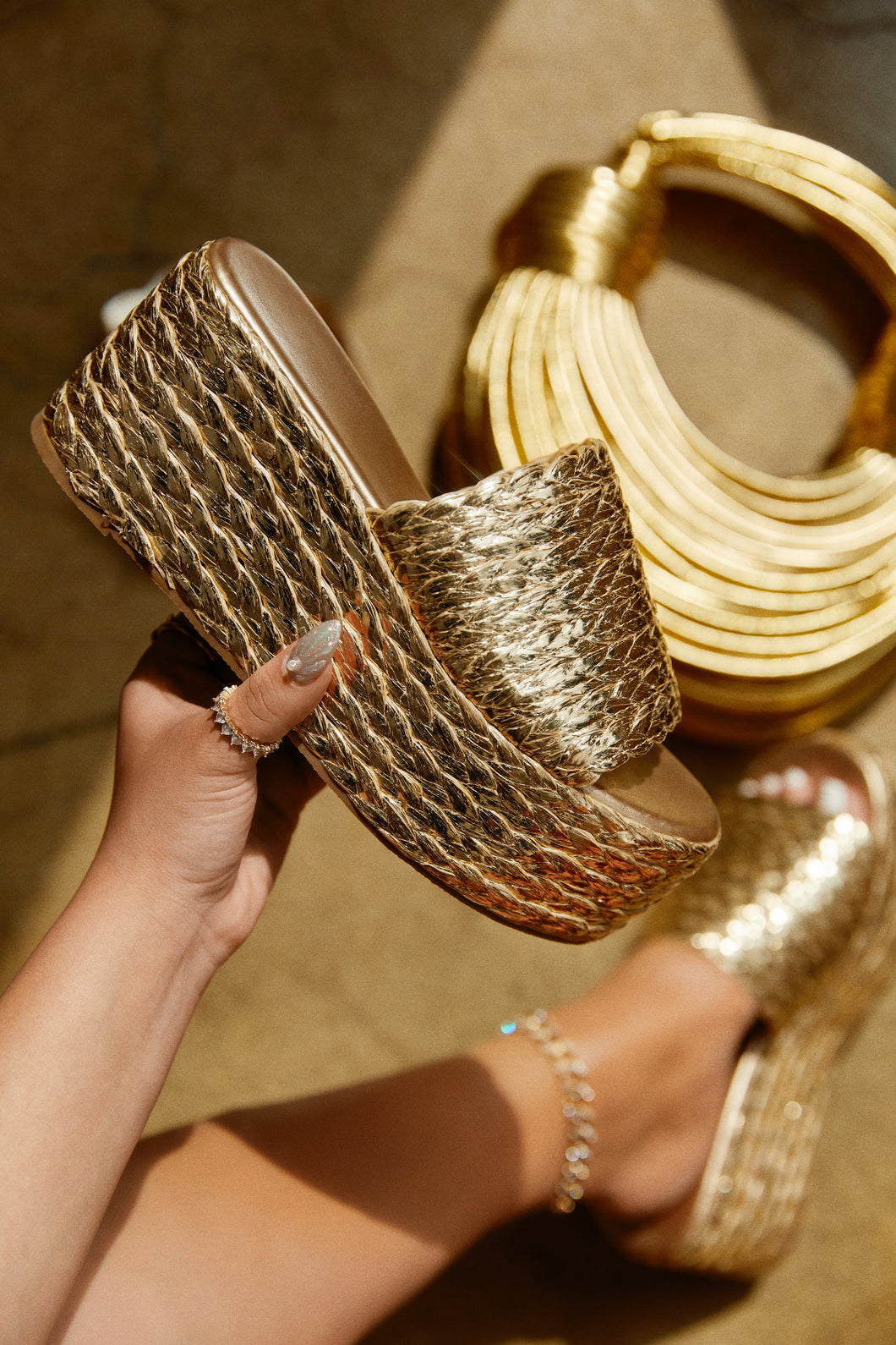 Women Holding Gold Espadrille Sandals