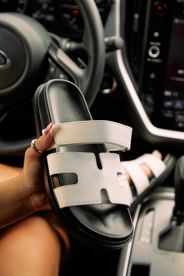 Load image into Gallery viewer, Women Holding White Sandals

