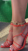 Strappy orange heel with unique bead looking heel