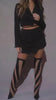Model wearing Black Two Piece Set Long Sleeve Crop Blazer with Waist Tie Detail High Waist Mini Skort Asymmetrical Hemline