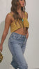 Model wearing gold embellished top