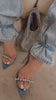 video of woman modeling blue denim rhinestone strappy pointed toe heel 