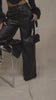 Model wearing black PU high waisted pants