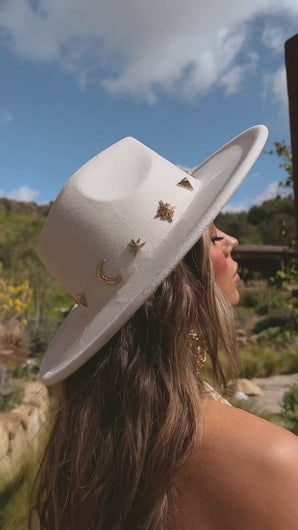Faux suede white hat with gold charms on model