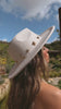 Faux suede white hat with gold charms on model