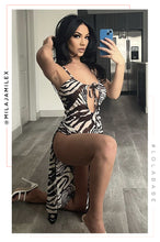 Load image into Gallery viewer, woman kneeling wearing sleeveless zebra print high slit dress 
