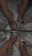 Load and play video in Gallery viewer, Woman wearing silver heels with embellished toe strap in front of mirror
