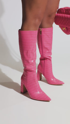 Video Of Model Wearing Embossed Croc Boots Available In Pink, Green, Tan, And Black 